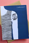 A blue greeting card with an illustration of half of someone’s torso and arm with tattoo of happy birthday and the text ‘I really mean it’.