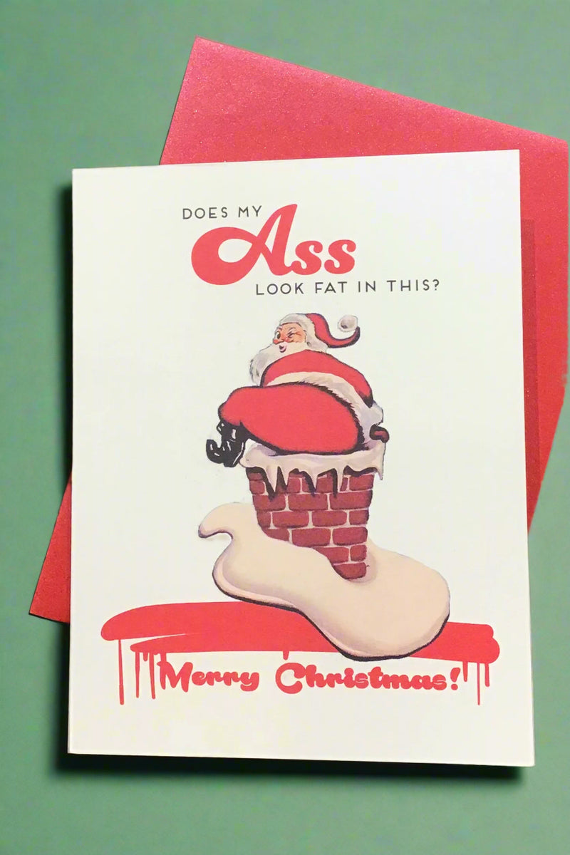 Card with the words “ Does my ass look fat in this? Merry Christmas!” and an image of Santa stuck in a chimney.