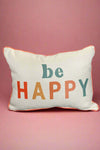 A rectangle white pillow with orange piping edges. It has ‘Be Happy’ written on the front.