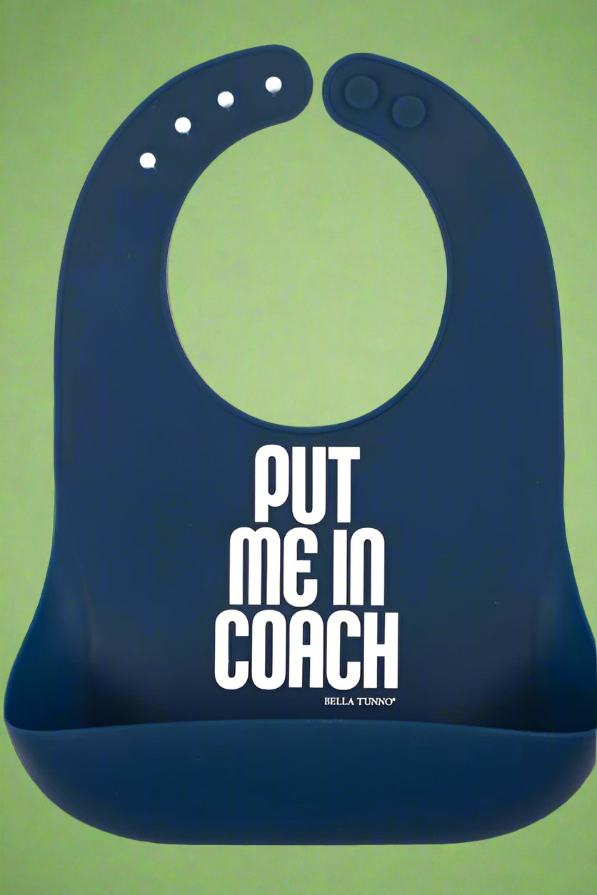 A navy blue, adjustable neck bib with ‘Put Me in Coach’ on the front. Recommended for 6 months+.
