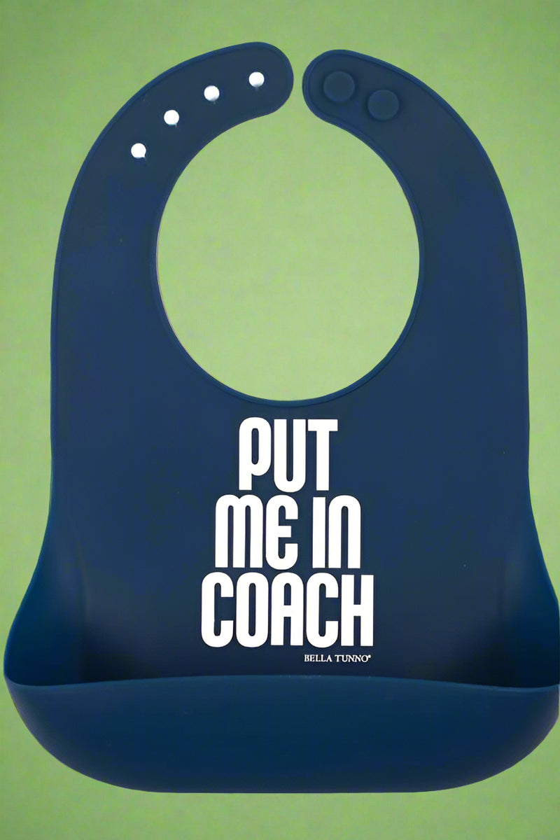 A navy blue, adjustable neck bib with ‘Put Me in Coach’ on the front. Recommended for 6 months+.