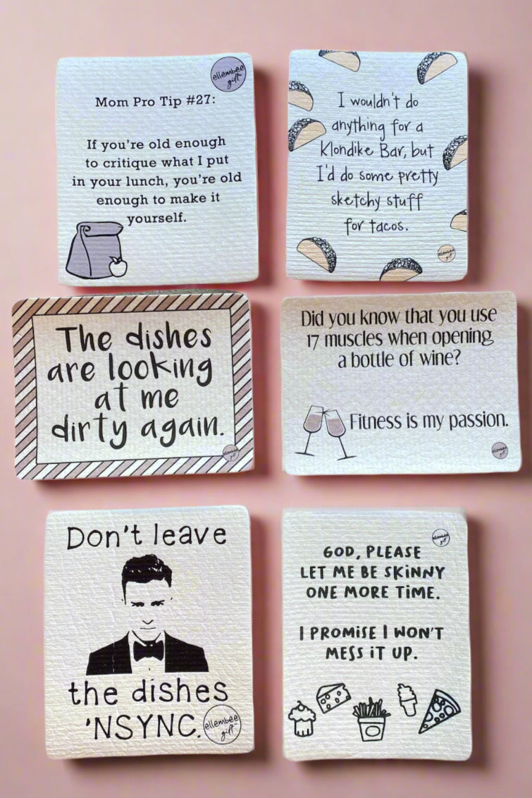 A photo of 6 different reusable cleaning cloths with funny sayings on them.