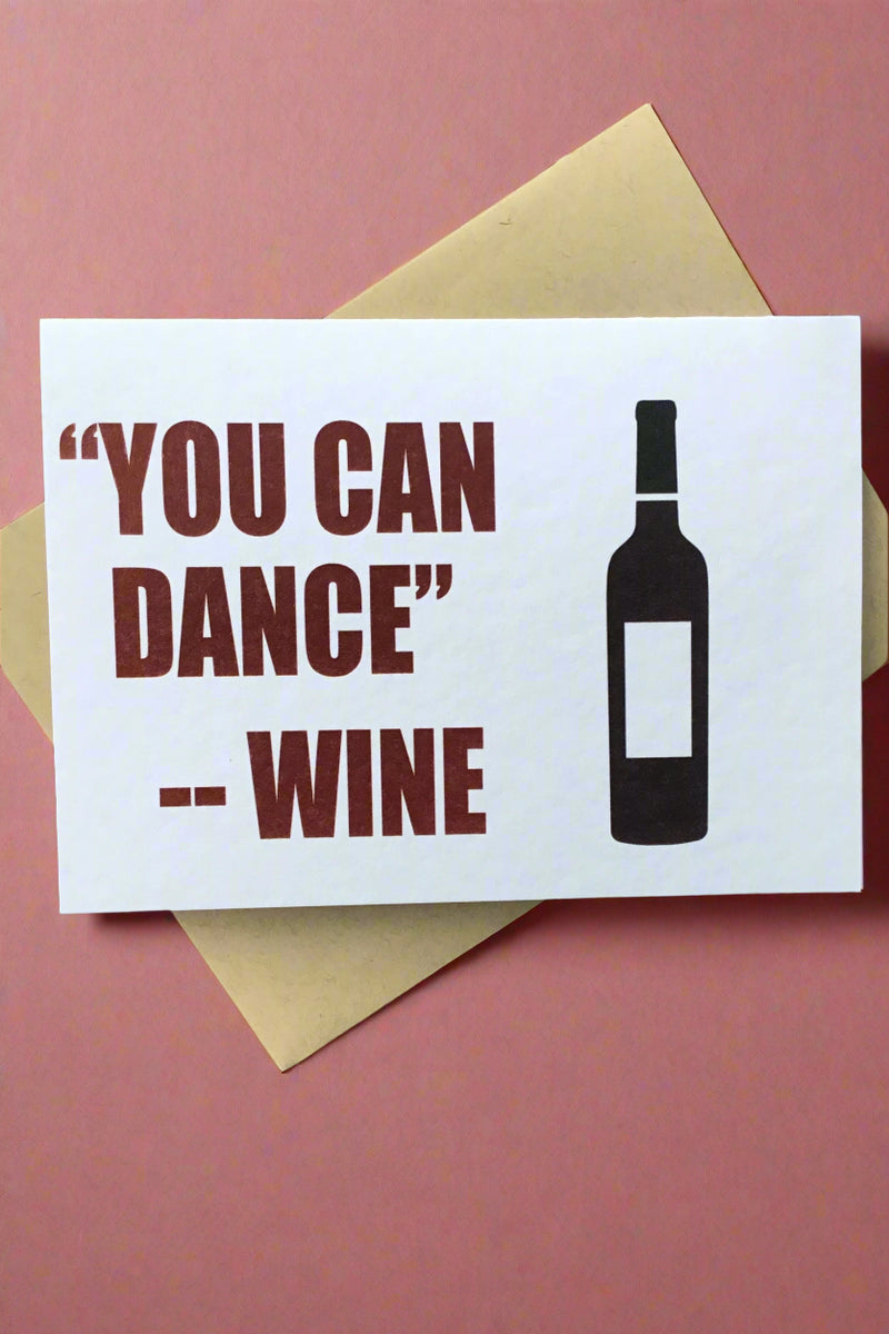A white card with an image of a wine bottle that says “you can dance’ — wine”