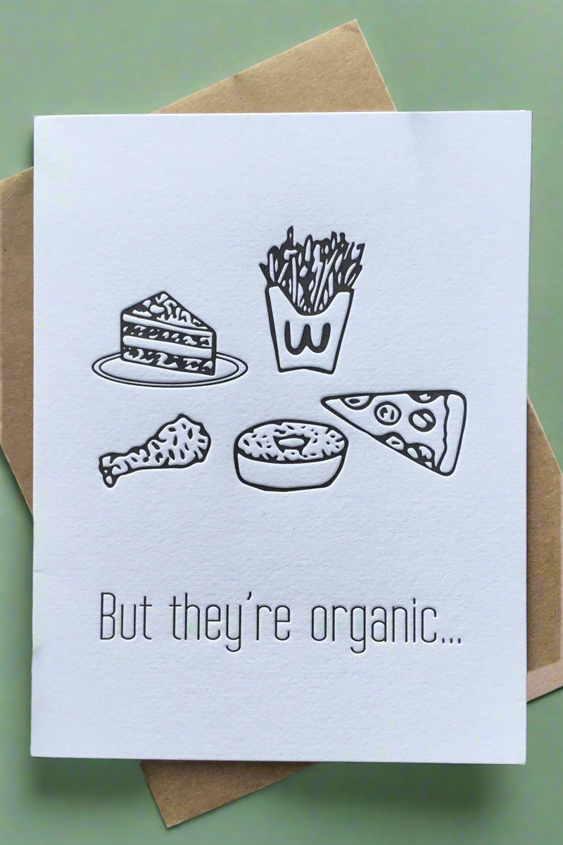 A white card with graphics of junk food and words “But they’re organic...”
