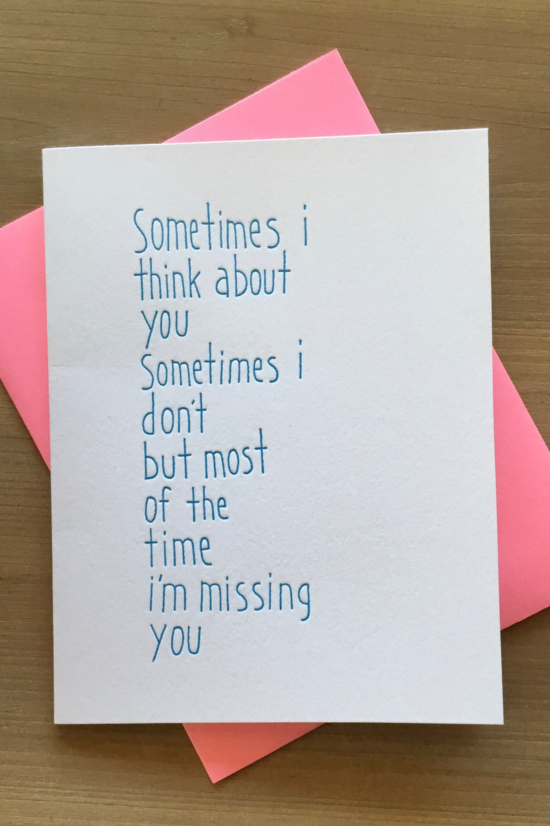 A white card that says “ Sometimes I think about you, sometimes I don’t. But most of the time I’m missing you.”