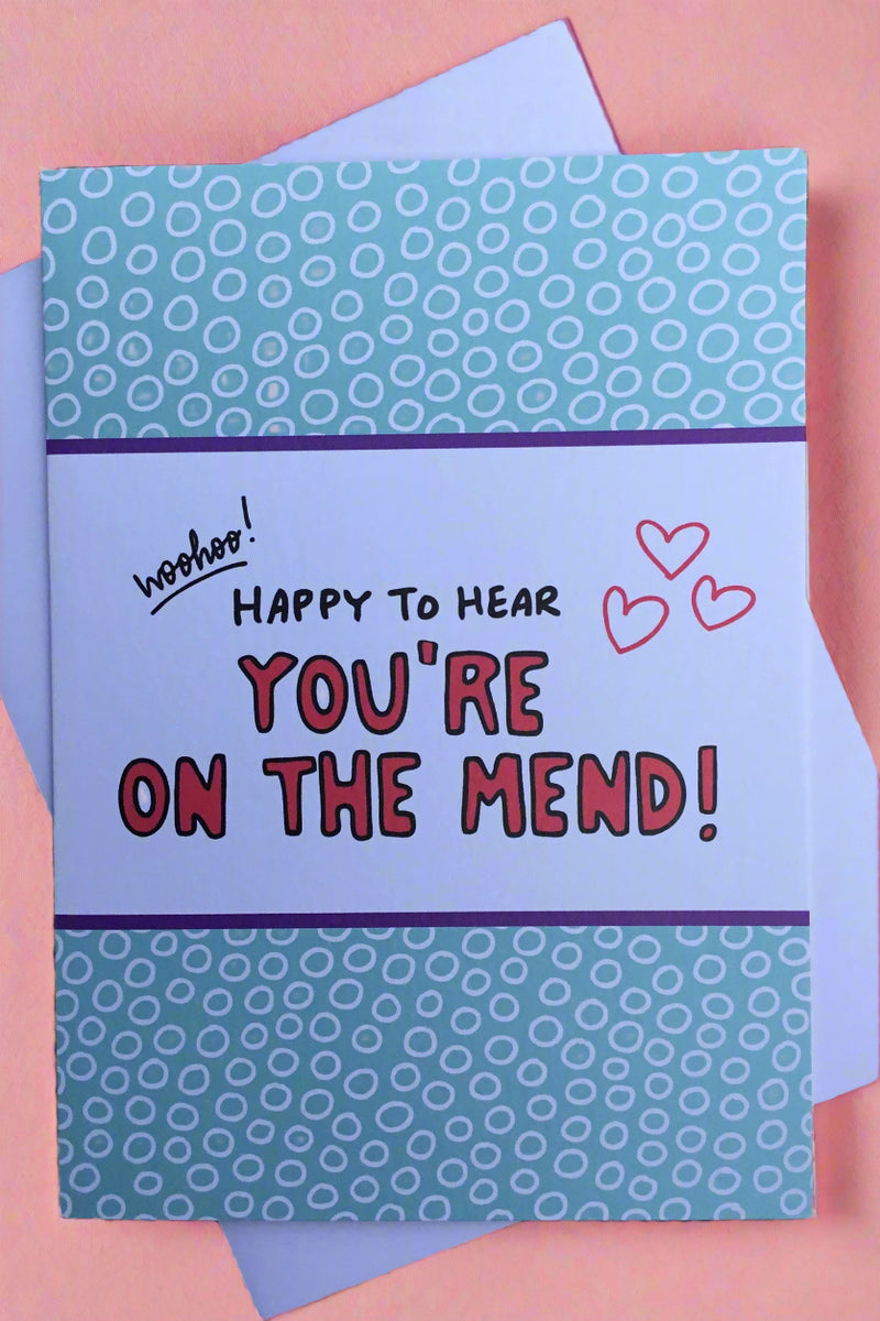 A card that says “ Woohoo! Happy to hear you’re on the mend!” with hearts and a blue background.