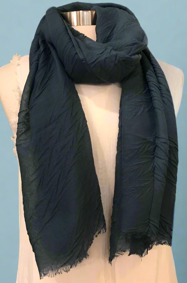 A simple, lightweight, black scarf with raw hem edges.