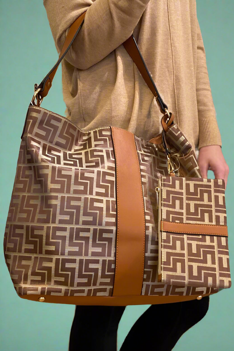 A large shoulder bag with a brown pattern features a zip closure and inside pockets. Includes an extra wristlet bag.