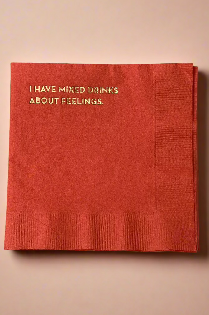 A red cocktail napkin with the phrase ‘I Have Mixed Drinks About Feeling’ on them.