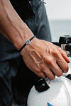 Model showcases the Osborne Bracelet, made from tires recovered from the ocean.