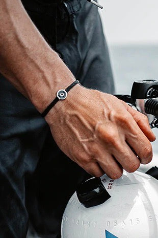 Model showcases the Osborne Bracelet, made from tires recovered from the ocean.