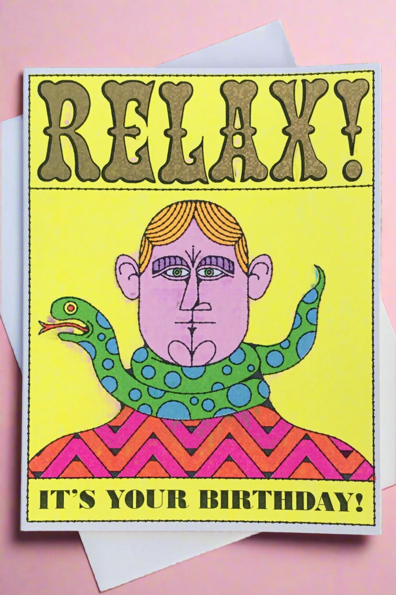 A greeting card in the style of an old circus poster with the image of a mad with a snake around his neck and text that reads ‘Relax! It’s your birthday!’