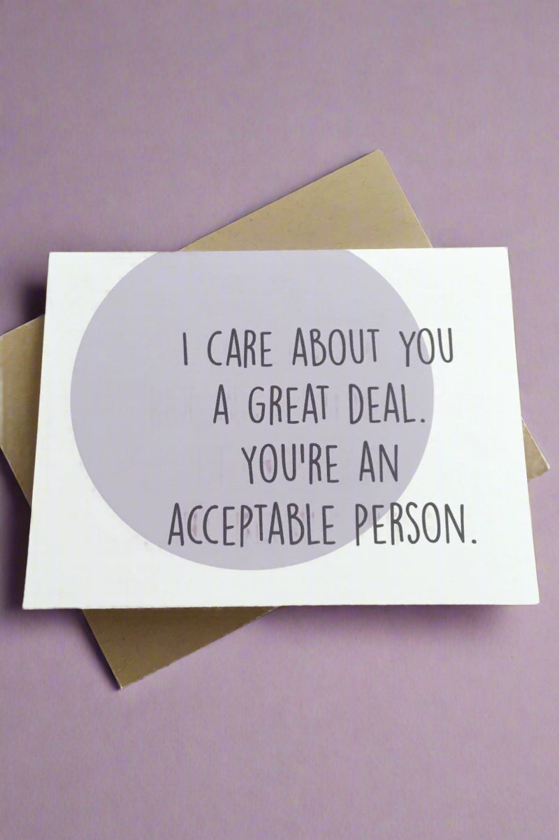 A white card with purple circle that says “ I care about you a great deal. You’re an acceptable person.”