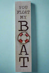A vertical rectangle sign that says “You Float My Boat.”