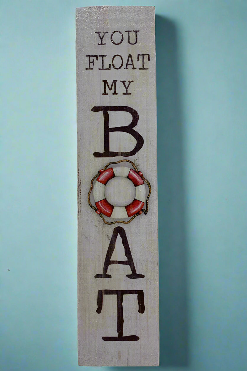 A vertical rectangle sign that says “You Float My Boat.”