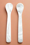 A set of two, silicone spoons in a marble color.