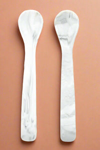 A set of two, silicone spoons in a marble color.
