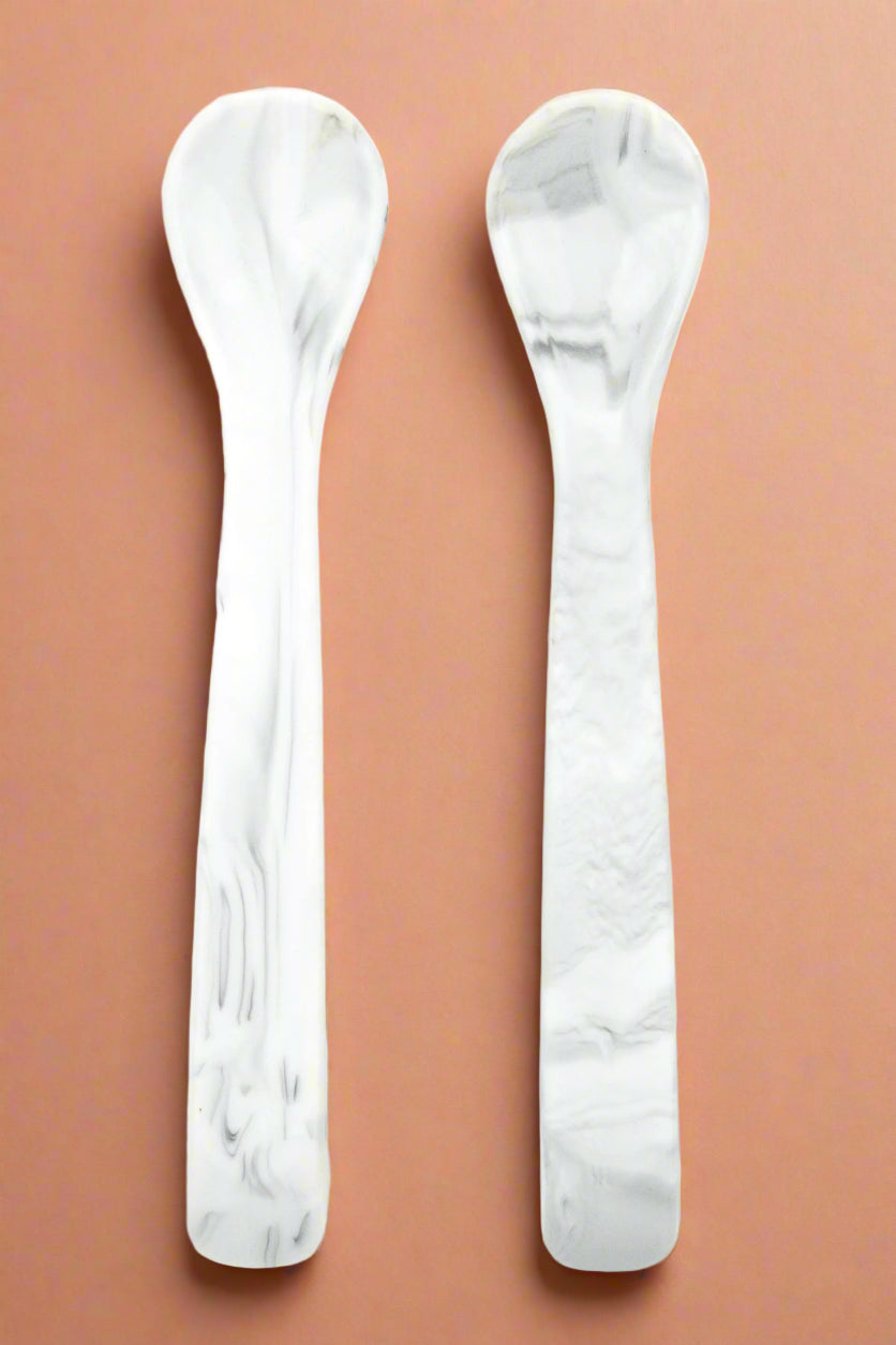 A set of two, silicone spoons in a marble color.