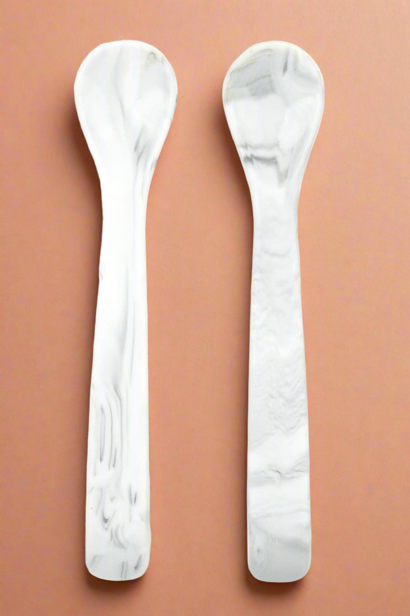A set of two, silicone spoons in a marble color.