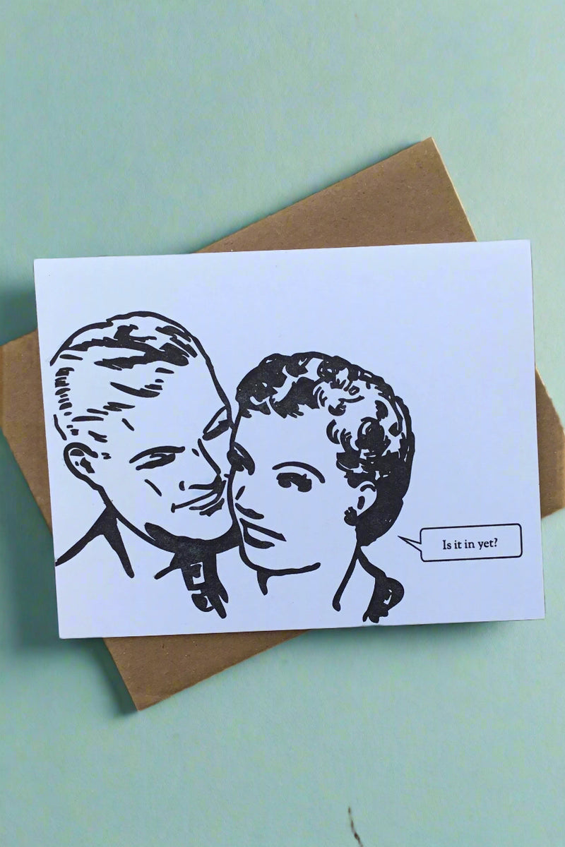 A white card with the head of a man and woman and text bubble that says “Is it in yet?”