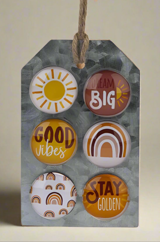 A set of 6 small round magnets. They feature rainbow and sunshine designs.