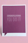 A simple greeting card with purple background and white text that reads ‘Congratulations! You Did It!’