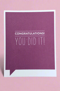 A simple greeting card with purple background and white text that reads ‘Congratulations! You Did It!’