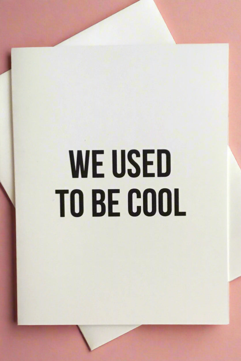A white card that says “we used to be cool.” 