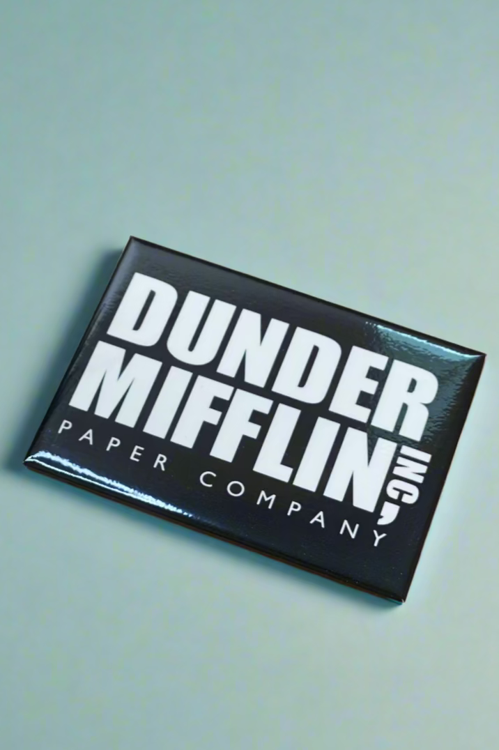 A The Office magnet that says “Dunder Mifflin Inc. Paper Company.”