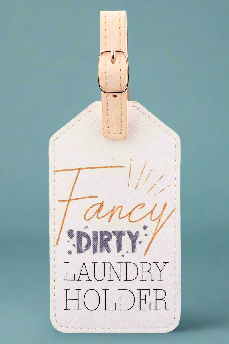 A white luggage tag that says “Fancy Dirty Laundry Holder.”