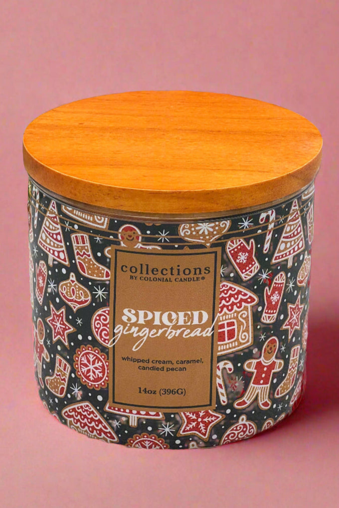 A large jarred candle with wooden lid and holiday themed wrap.