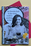 A card with an image of a woman in bed with tray laden with food and says “my favorite food in the whole world is anything in bed.”