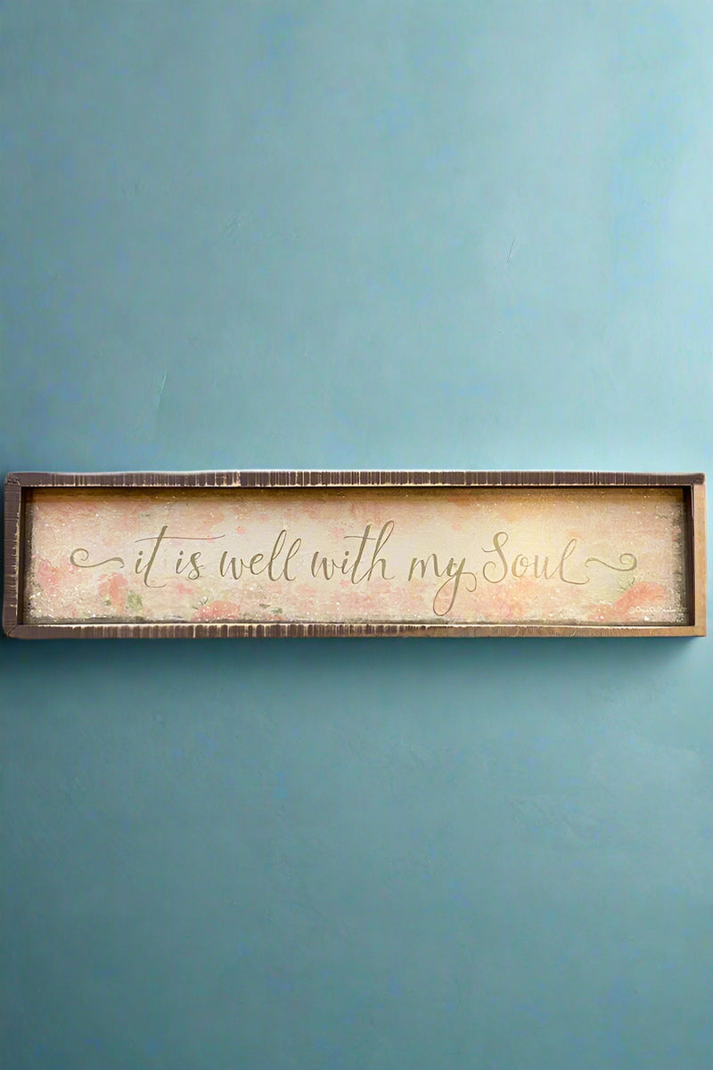 A wood framed sign that says “it is well with my soul.”
