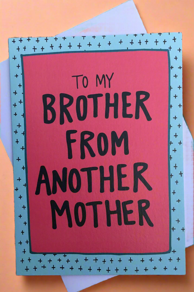 A red card with blue border that says “ To my brother from the another mother.”