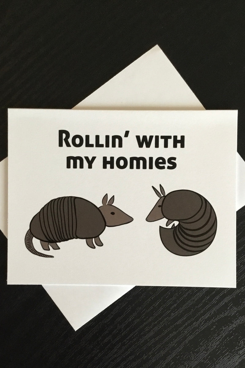 An off white card fe two armadillos and says “Rollin’ with my homies.”