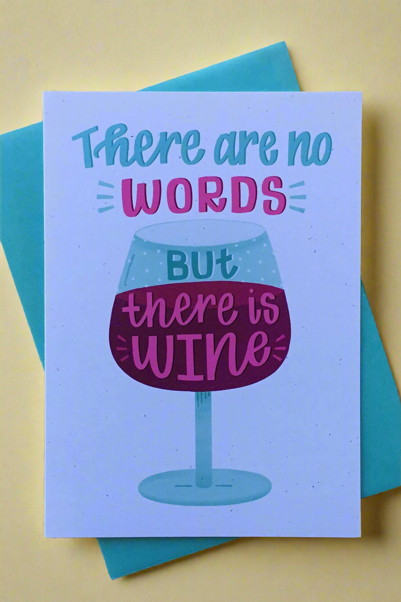 A white card that say “There Are No Words But There Is Wine” and an image of a wine glass.