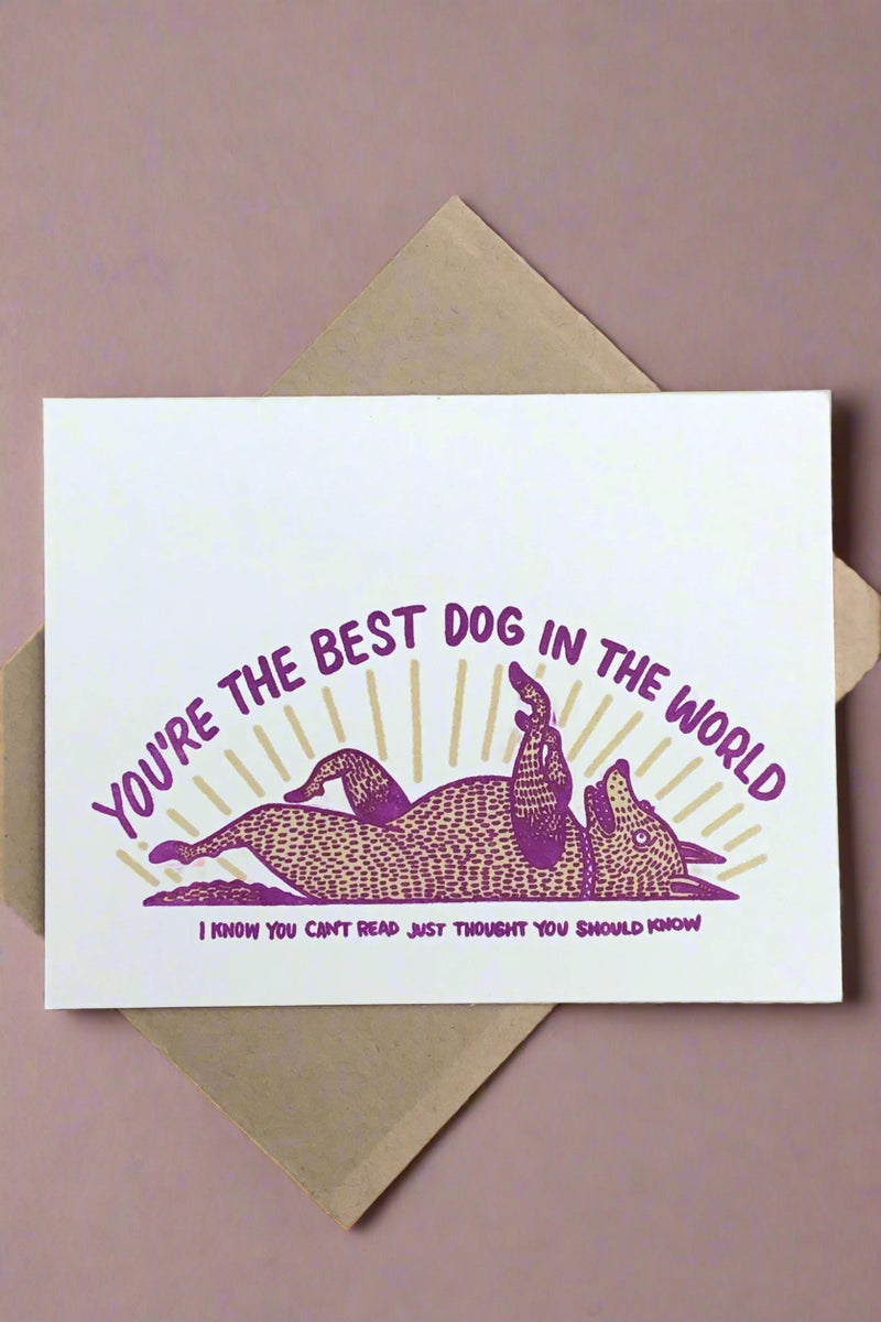 A white card with a dog laying on its back that says “You’re the best dog in the world. I know you can’t read just thought you should know.“