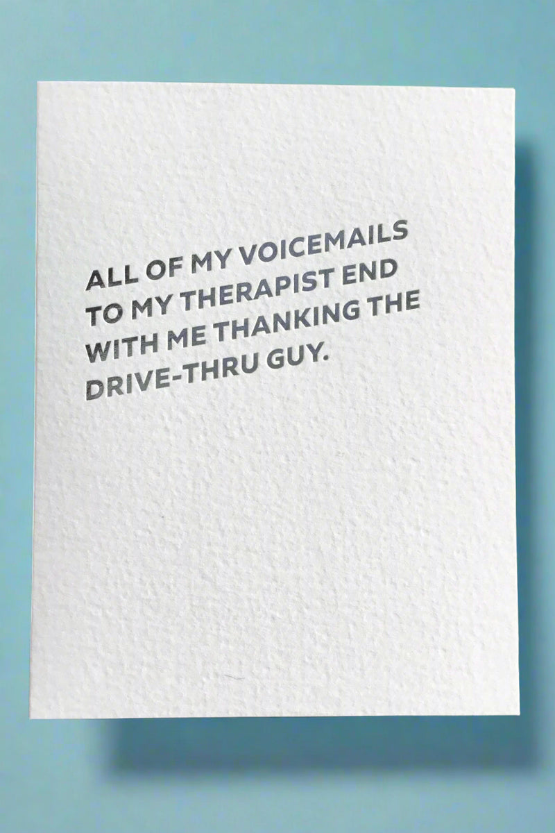 A minimalist greeting card with silver text that reads ‘All of my voicemails to my therapist end with me thanking the drive-thru guy.’
