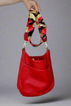 Medium sized crossbody bag that is large enough to fit an Ipad and more! Vibrant red color with an outside pocket and removable metallic guitar strap. 