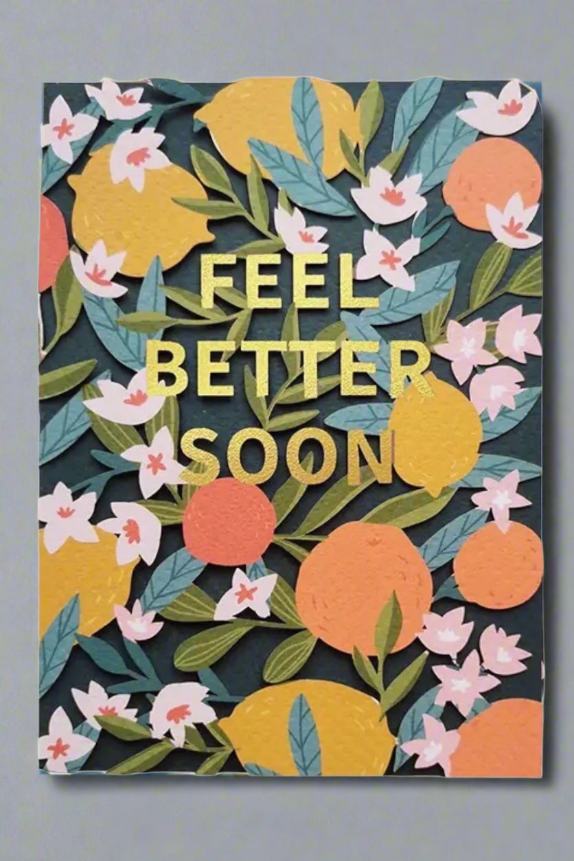 A colorful botanical card that says “feel better soon” in cold.