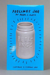 A ceramic, glazed jar that has ‘feeling’ etched on the front.