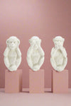 A set of 3, white monkey figurines. Each monkey displays hear no evil, see no easily, or speak no evil. 