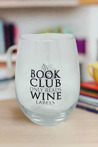 Clear stemless wine glass that reads, “My book club only reads wine labels”.