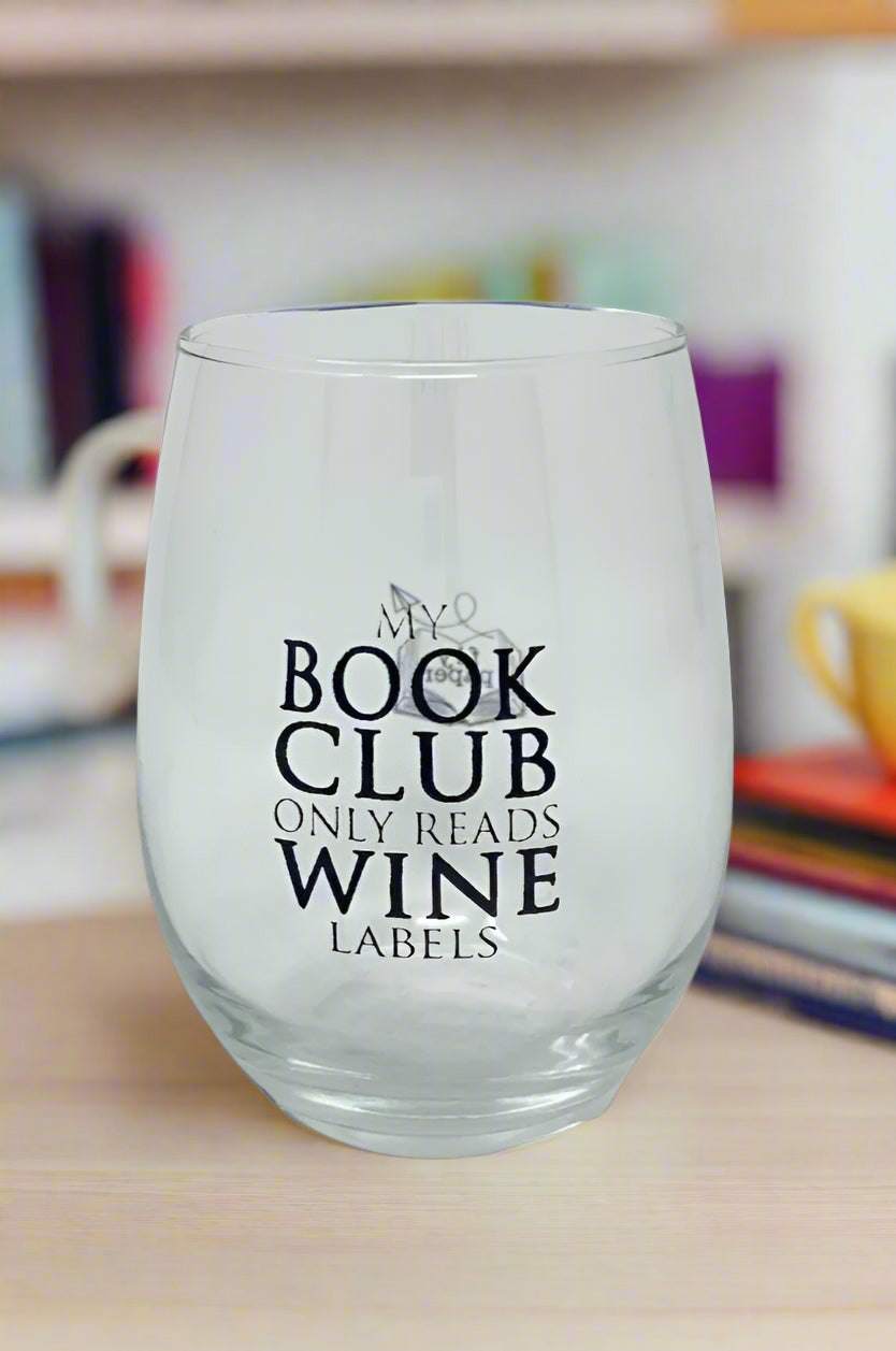 Clear stemless wine glass that reads, “My book club only reads wine labels”.